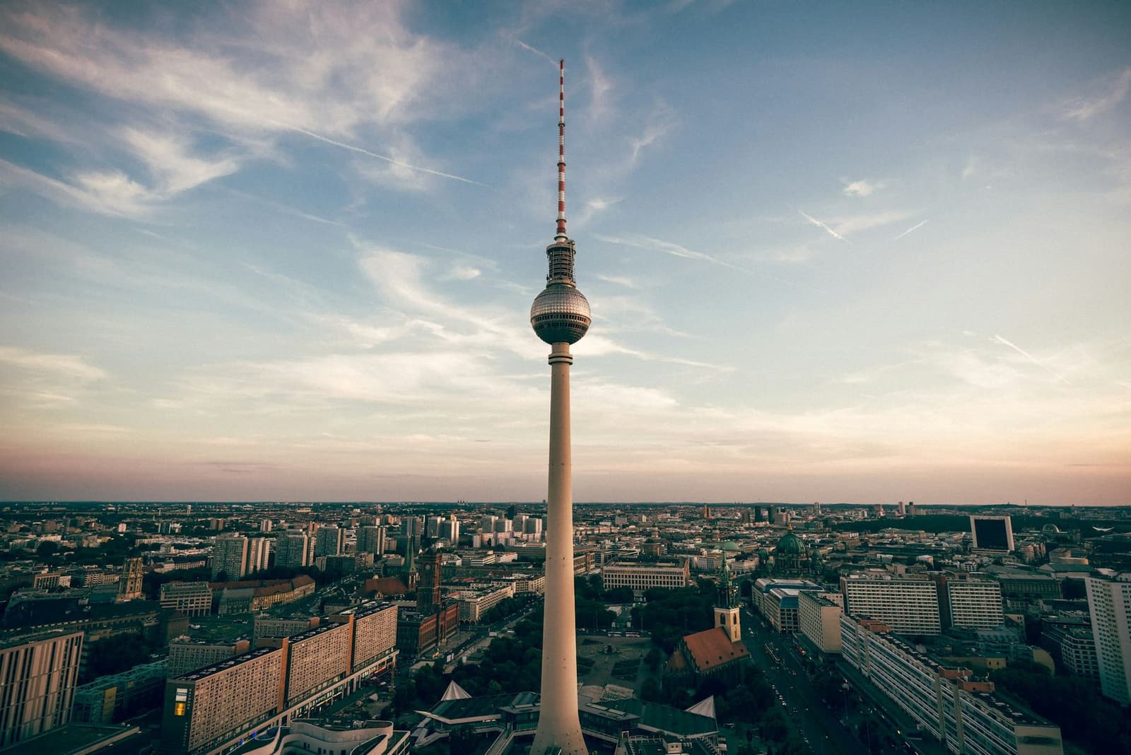 Aerial view over Berlin at dusk with the base of the TV tower in the foreground