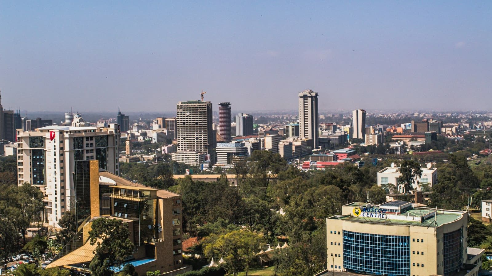 The Nairobi skyline on a clear day above tree-lined streets