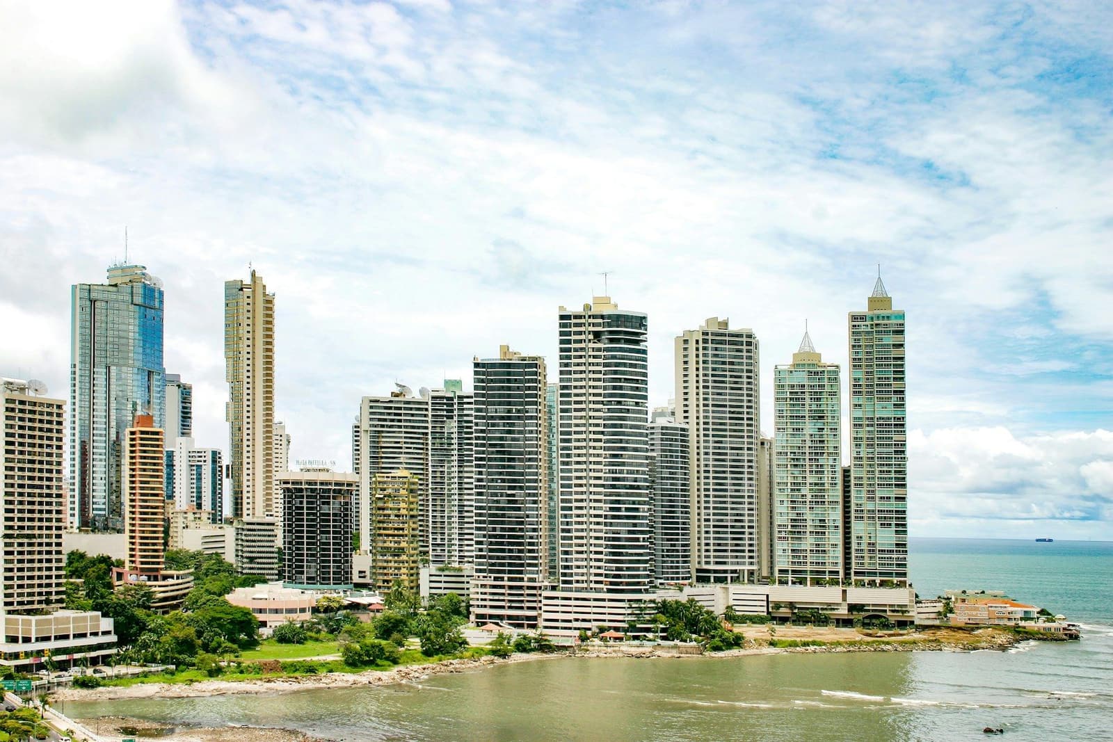 Panama City high-rise towers along the waterfront under a blue sky