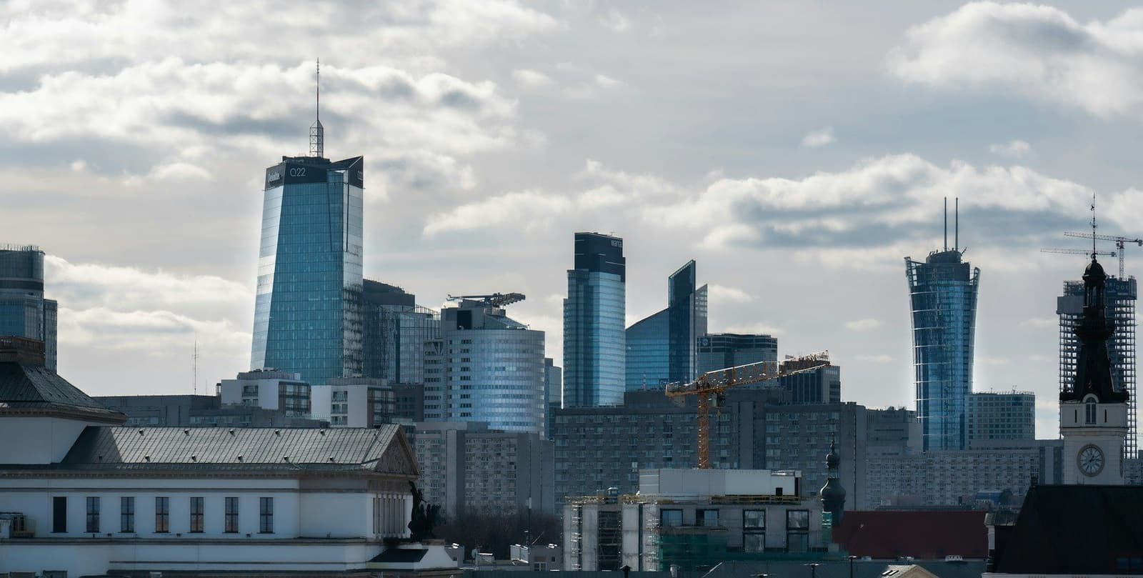 Warsaw's modern business district skyline under a cloudy sky