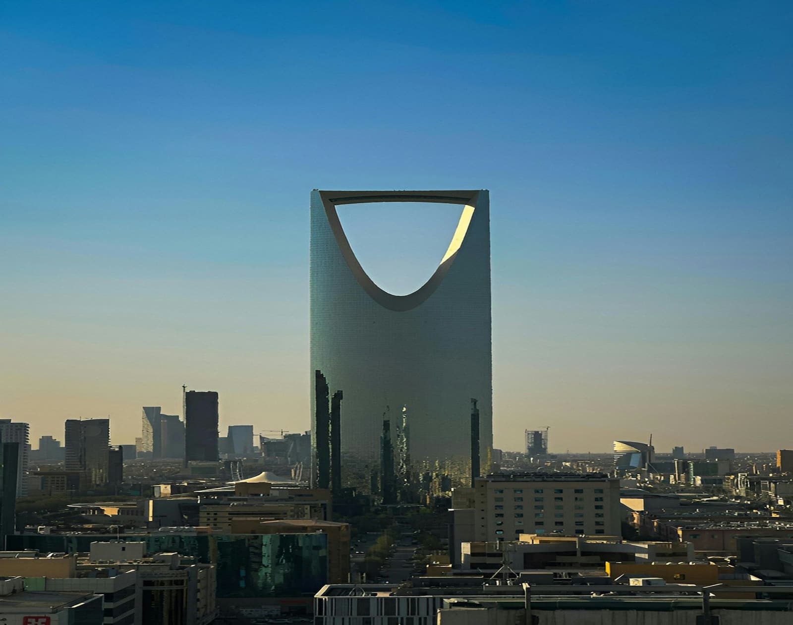 The Kingdom Centre tower rising above the Riyadh skyline at dusk