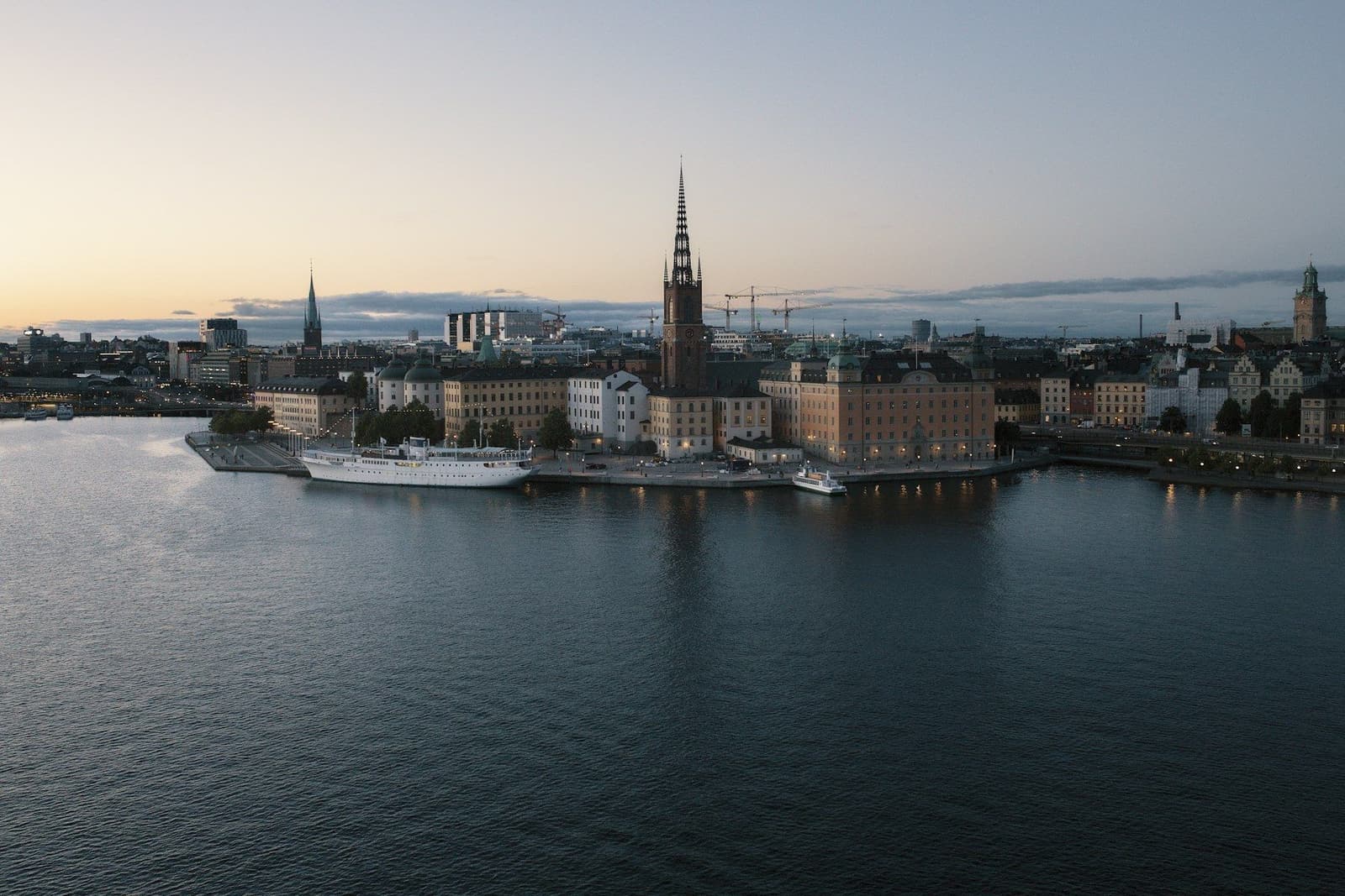 Stockholm's Riddarholmen island and church spire across calm water at dusk